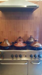 a group of pots sitting on top of an oven at HOTEL BEACH CLUB LEGZIRA in Sidi Ifni