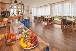 eine Küche und ein Esszimmer mit Obst auf dem Tisch in der Unterkunft Pension Haus Antje in Ahlbeck