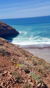 a view of the ocean from a rocky beach at HOTEL BEACH CLUB LEGZIRA in Sidi Ifni