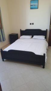 a large bed with white sheets and pillows in a bedroom at HOTEL BEACH CLUB LEGZIRA in Sidi Ifni