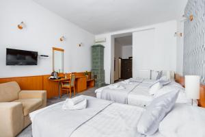 Habitación de hotel con 2 camas y sofá en Budapest Griffin Guest House, en Budapest
