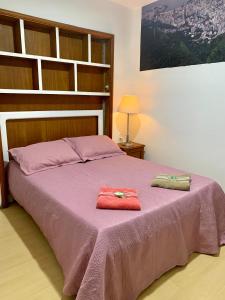 a bedroom with a bed with two towels on it at 4 bedroom at the beach in Rio de Janeiro