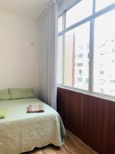 a bedroom with a bed and a large window at 4 bedroom at the beach in Rio de Janeiro