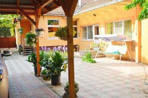 a patio with plants and a house at Затишні Апартаменти Берегове in Berehove