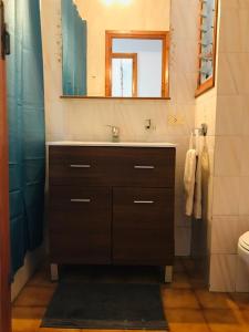 a bathroom with a sink and a mirror at Casa 3 dormitorios Cala Galdana in Cala Galdana