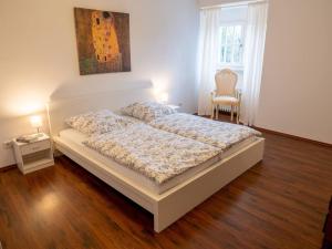 a bedroom with a bed and a table and a chair at Messe-Apartment in Essen