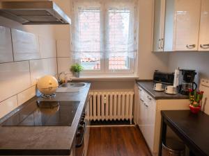 a kitchen with a sink and a stove top oven at Messe-Apartment in Essen