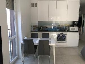 a kitchen with a table and chairs in a room at Apartament bursztynowy in Jantar