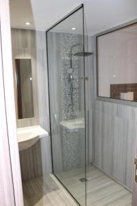 a glass shower in a bathroom with a sink at Fedrania Gardens Hotel in Ayia Napa