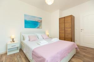 Postel nebo postele na pokoji v ubytování Holiday Apartments Dubrovnik