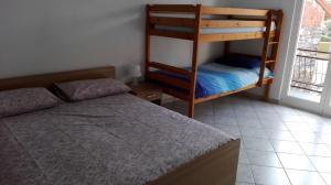a bedroom with two bunk beds and a window at Panorama sul lago in Porto Valtravaglia