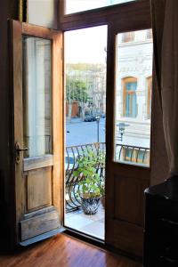 an open door leading to a room with a window at Guesthouse Medea on Pushkini 4 in Kutaisi