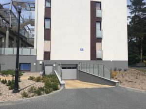 a building with a ramp leading to a garage at Apartament bursztynowy in Jantar +5 photos