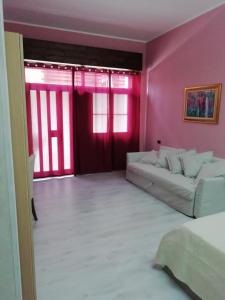 un soggiorno con divano bianco e pareti rosa di Mattei Domus a Lesina