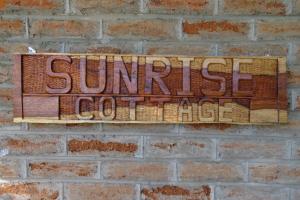 a sign on a brick wall that reads at Gateway Guest House in Monkey Bay