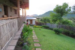 a backyard of a house with a fence at Gateway Guest House in Monkey Bay