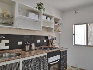 a kitchen with a sink and a counter top at Casa Belinda in San Nicolás