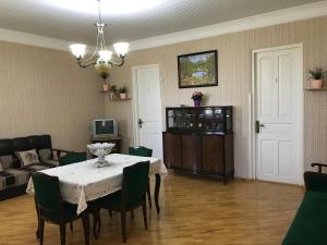 a living room with a table and a couch at Sweet Memories in Kutaisi