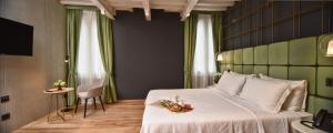 Posteľ alebo postele v izbe v ubytovaní Hotel Maison Ducal
