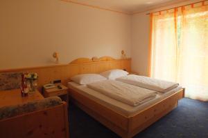 Postel nebo postele na pokoji v ubytování Hotel Residence Olympia