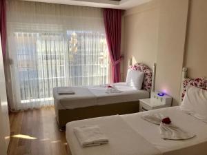 a hotel room with two beds and a window at White Star Antalya in Antalya +71 photos