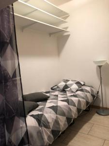 a bedroom with a bed with black and white sheets at VVA in Conques-sur-Orbiel
