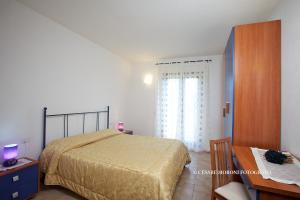 Katil atau katil-katil dalam bilik di Residence Ai Campi Da Golf Saturnia