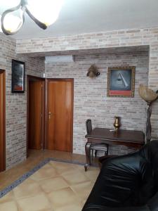 a living room with a table and a brick wall at Carrer Roma in Sagunto