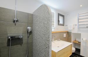 a bathroom with a shower and a sink at Residence Kalliste in Ajaccio