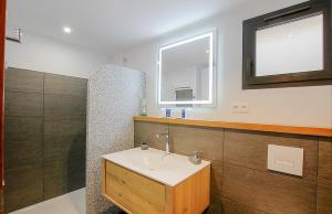 a bathroom with a sink and a mirror at Residence Kalliste in Ajaccio