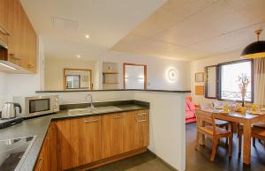 a kitchen with a table and a dining room at Residence Kalliste in Ajaccio