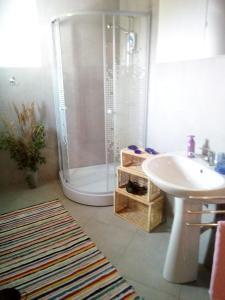 a bathroom with a shower and a sink at Pensiunea La Poarta Bucovinei in Suceava