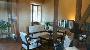 a living room with a couch and a table and a chair at Hotel Parador Vichuquen in Vichuquén