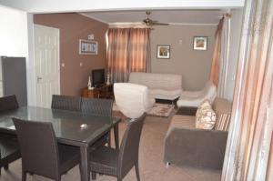 a living room with a table and a dining room at Sun Villa Mont Choisy Apartments in Mont Choisy