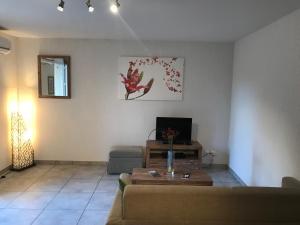 a living room with a couch and a table at Le Domaine du Thronnet in Figanières