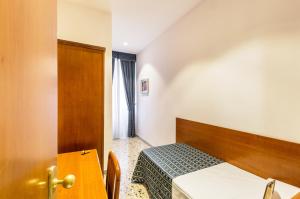 Postel nebo postele na pokoji v ubytování Hotel Tempio Di Pallade