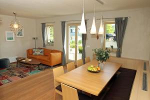 a dining room and living room with a table and chairs at Apartma - Počitniška hiša Lodi in Bohinj