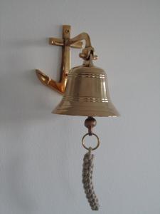 a bell with a tassel hanging on a wall at Ankerhaus Ostholstein in Oldenburg in Holstein