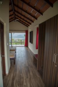 a hallway with a room with a pool table at Sunset Valley Homestay in Chikmagalūr