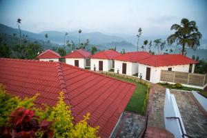 a row of houses with red roofs at Sunset Valley Homestay in Chikmagalūr