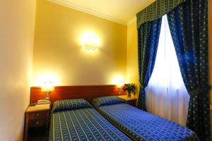 Postel nebo postele na pokoji v ubytování Hotel Tempio Di Pallade