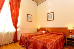 Postel nebo postele na pokoji v ubytování Hotel Tempio Di Pallade
