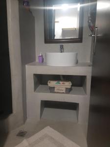 a bathroom with a white sink and a mirror at Elaia country living in Galatas +33 photos