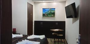 a hotel room with a bed and a television at Nino's Hotel On Tsamebuli in Tbilisi City