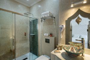 a bathroom with a glass shower and a sink at Emma's Riad in Marrakesh