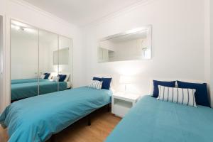 מיטה או מיטות בחדר ב-Living Las Canteras Homes - BEACH HOME