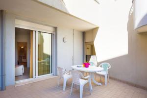a white table and chairs on a patio at Villa Maria in Caorle