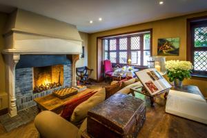 a living room with a fireplace and a table at Luxury Guesthouse Bonifacius - unique location in Bruges