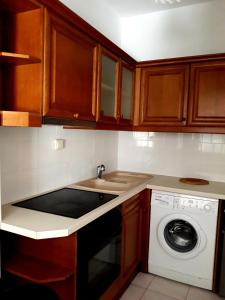 a kitchen with a sink and a washing machine at Sitia Holidays 1 in Sitia