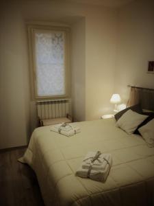 a bedroom with a bed with two towels on it at B&B Casa Lilli in Foligno